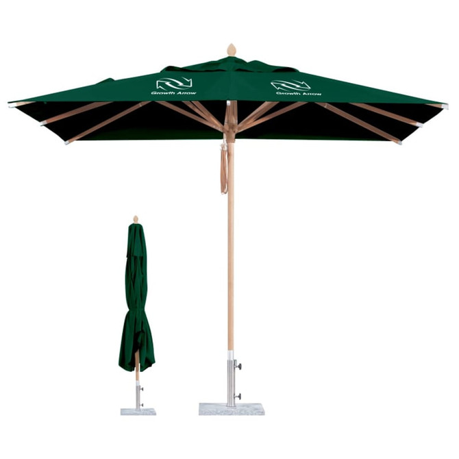A green outdoor umbrella with a square canopy, featuring a wooden pole and a base, alongside a folded umbrella.
