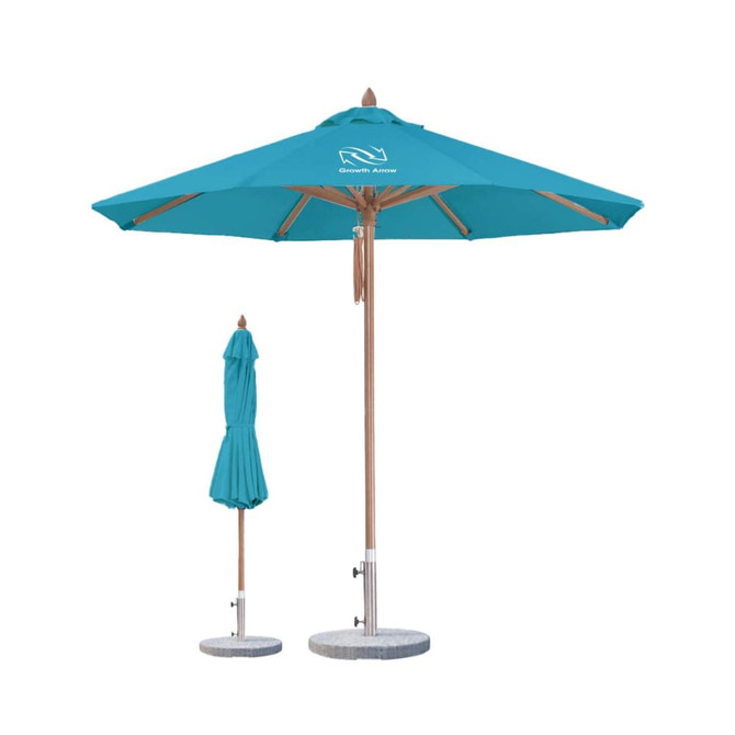 A teal, wind-resistant octagon outdoor umbrella with a wooden frame and a smaller folded umbrella beside it.