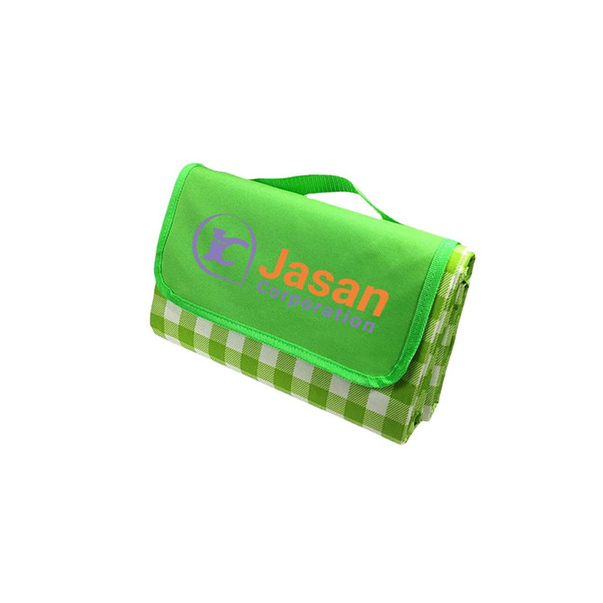 A large picnic blanket featuring a green top and a checkered pattern, folded with a handle and a logo.