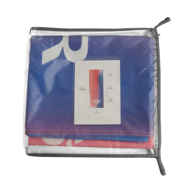 A large table runner in shades of blue and red, stored in a transparent zippered bag with a card insert inside.