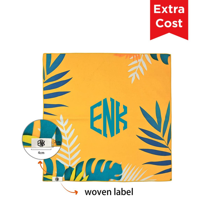 A vibrant yellow self-adhesive cloth with tropical leaf designs and a woven label in the corner.