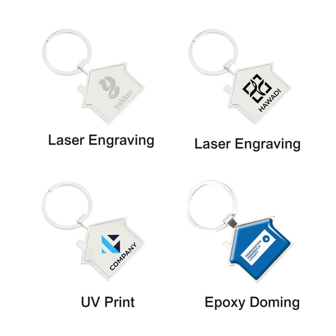 A house-shaped metal keyring in silver with a blue variant displayed, featuring various logo designs.