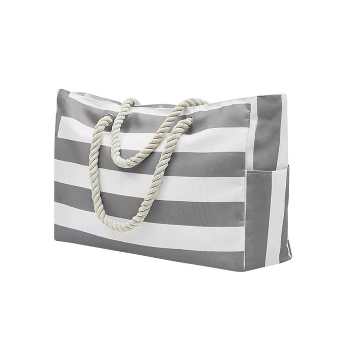 A grey and white striped beach bag with a rope handle and a side pocket. It features a logo on one side.