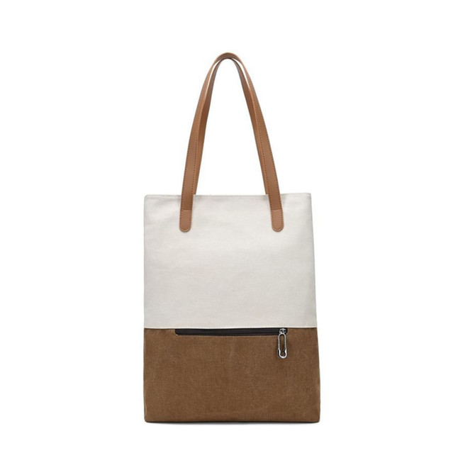 A convertible canvas backpack to tote bag in cream and brown with two tan straps and a zippered front pocket.