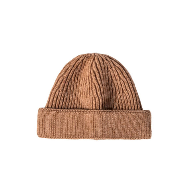 A round beanie in a warm brown colour, featuring ribbed texture and a rolled hem. It has a logo present.