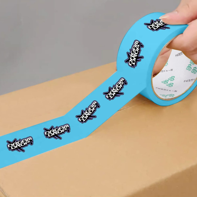A roll of blue BOPP packaging tape featuring a logo design, partially applied to a cardboard box.