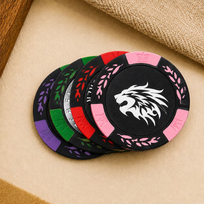 A set of black poker chips with colourful accents in green, purple, pink, and a lion logo in the centre.