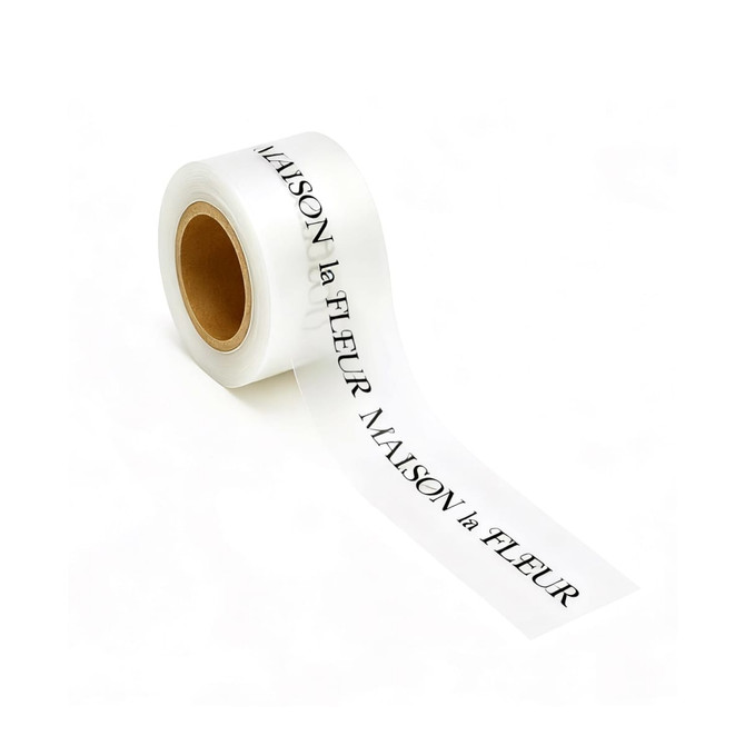A roll of white screen printed TPU soft ribbon with black lettering, featuring a logo.