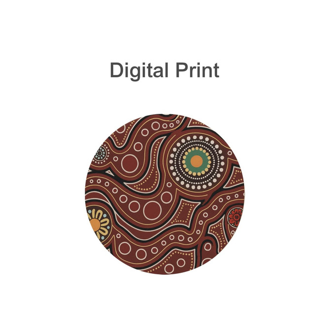A round diatomaceous coaster featuring a vibrant digital print in earthy tones of red, green, and white.