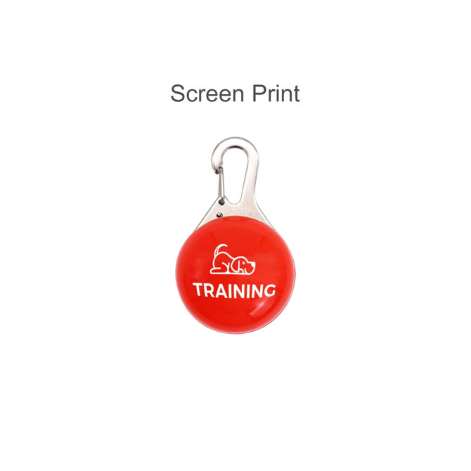 A red training clicker with a silver clip, featuring a dog graphic and the word "TRAINING."