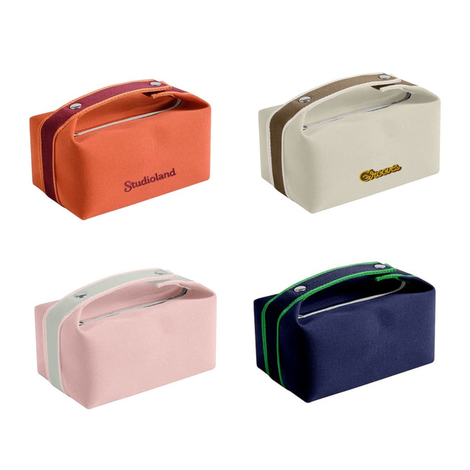 A portable canvas cosmetic bag in orange, cream, pink, and navy, featuring zippers and handles. Some have branding.