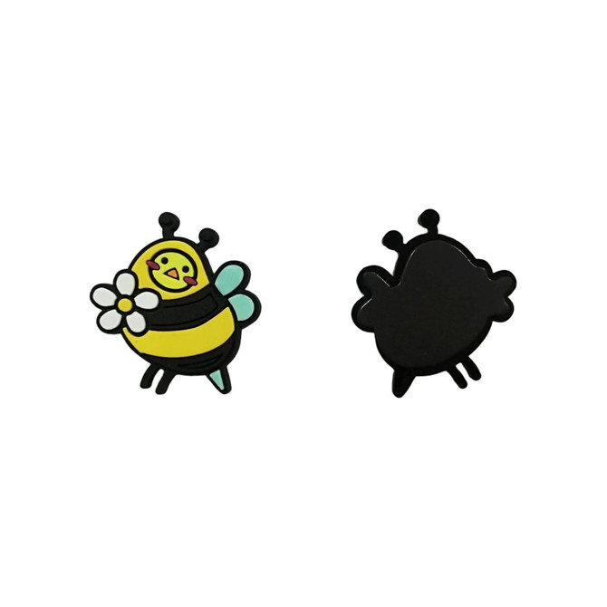 A bee-shaped PVC fridge magnet in yellow and black, featuring a flower, with a smooth black backside.