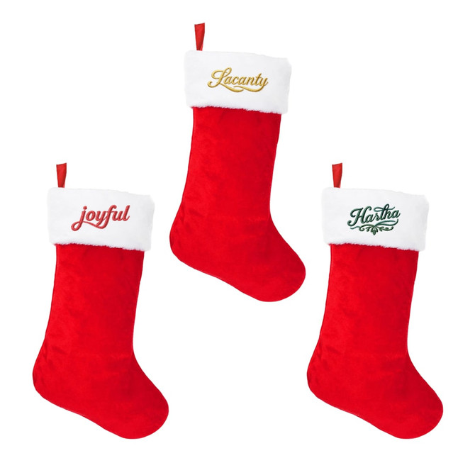 A trio of red and white embroidered Christmas stockings with decorative fur tops and various embellishments.