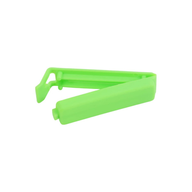 A green food bag seal clip designed to securely close packaging. It features a simple, ergonomic shape.