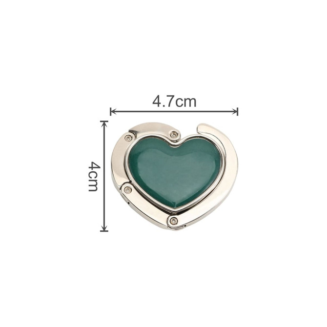 A heart-shaped foldable desk hook in silver and teal, featuring decorative accents and measuring 4.7 cm by 4 cm.