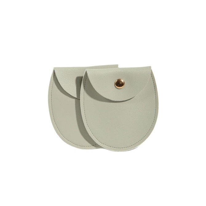 A set of two oval-shaped, light grey PU leather jewelry pouches with a gold-tone snap closure.