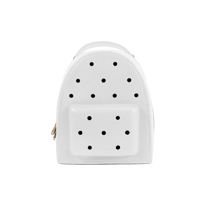 A white backpack with black polka dots and a front pocket, featuring a handle on top and a zipper closure.