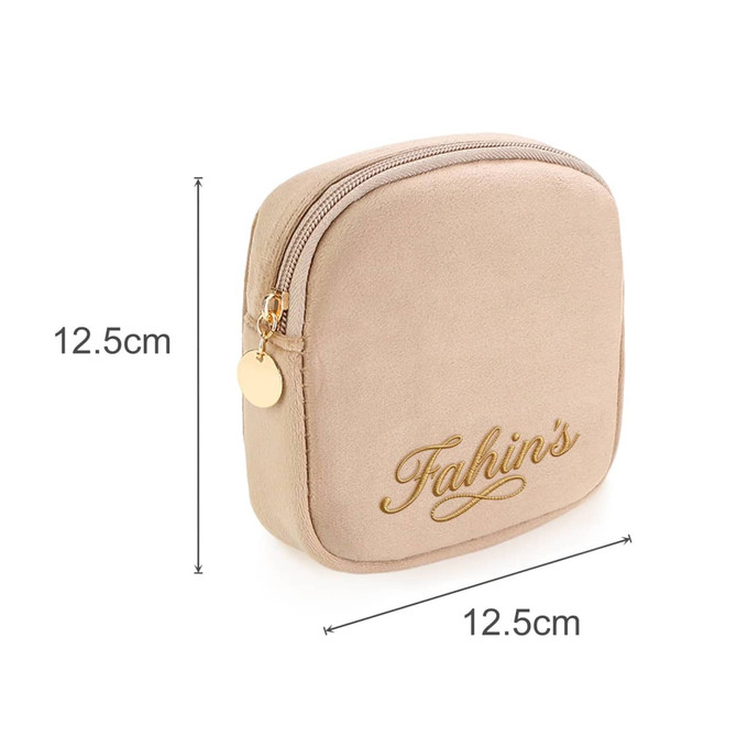 A stylish mini makeup bag in a soft beige hue, featuring a zipper and a logo. Dimensions are 12.5cm x 12.5cm.