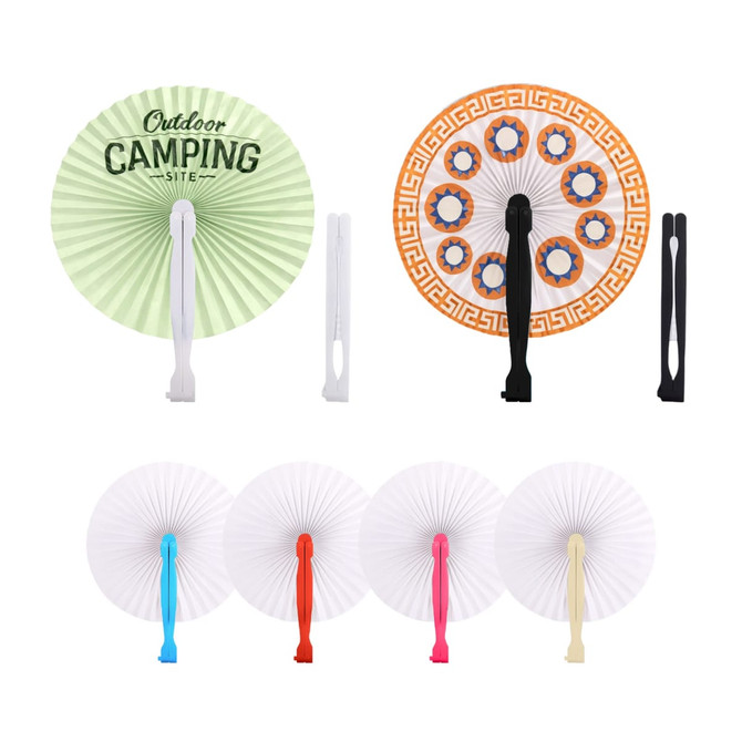 Round plastic paper fans in various colours, featuring green, white, black, and orange designs with different patterns.