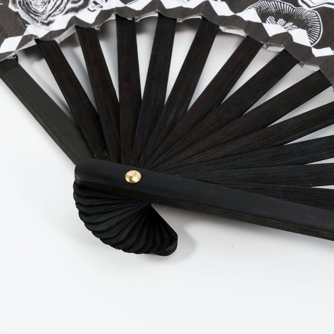 An 8-inch bamboo fabric hand fan with a black wooden frame and decorative fabric design featuring shades of white and black.