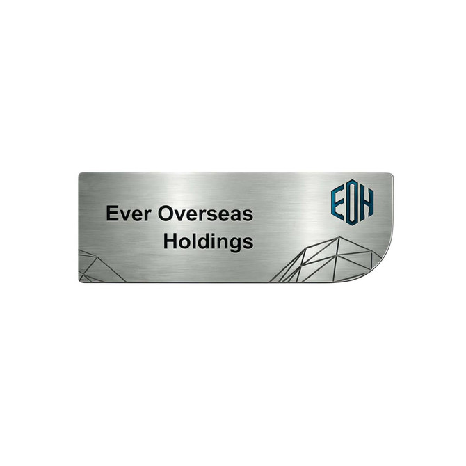 A custom metal name badge in silver with geometric designs and a logo on the side.