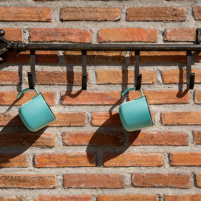 A drink bottle with an insulated design, featuring a light turquoise colour and a hanging loop, displayed on a brick wall.