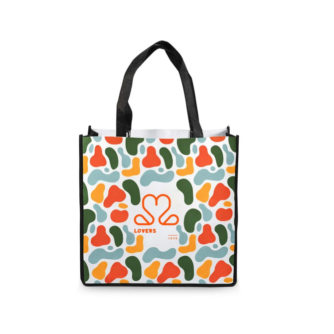 A vibrant tote bag with an abstract pattern of green, orange, red, and light blue shapes. It features a logo.