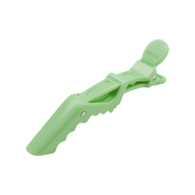 A green alligator clip with a textured grip and positioning features, designed for anti-slip functionality.