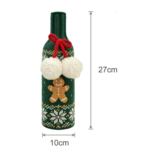 A drink bottle is wrapped in a green knitted sleeve, featuring a gingerbread man and white pom-poms.