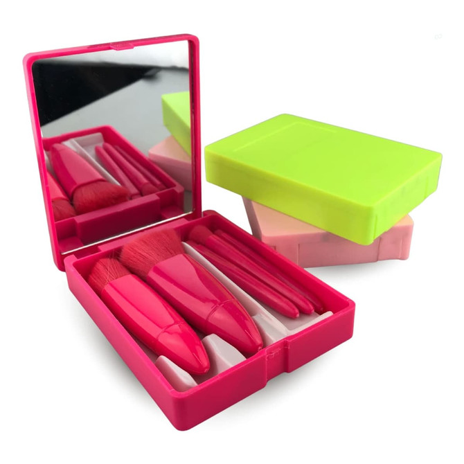 A pink and green plastic box containing five makeup brushes and a mirror.