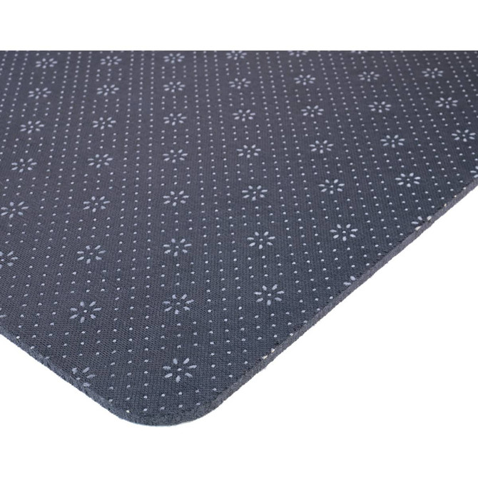 A dark grey desk mat features a textured pattern with small floral designs, showcasing rounded edges.