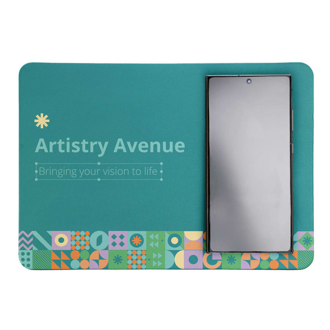 A teal mouse pad with a geometric design, featuring a smartphone placed on it, and a logo at the top.