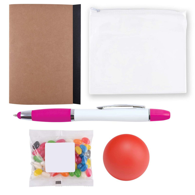 A brown notebook, a white zip pouch, a pink and white pen, a red stress ball, and a bag of colorful candies.