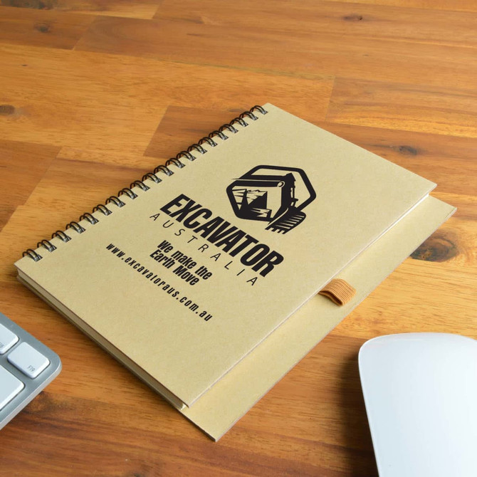 A brown spiral-bound notebook with an elastic strap, featuring a logo and branding on the cover.