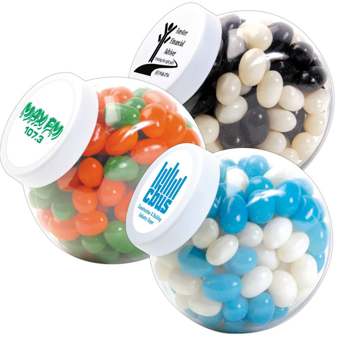 A container filled with mini jelly beans in various colors, including orange, green, black, and white, with branding on the lid.