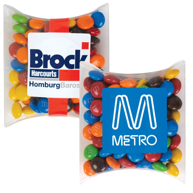 A pillow pack containing colorful M&M's chocolate candies, featuring a branding logo on one side.