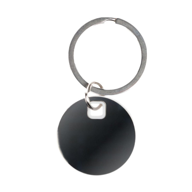 A circular black stainless steel keytag attached to a silver key ring.