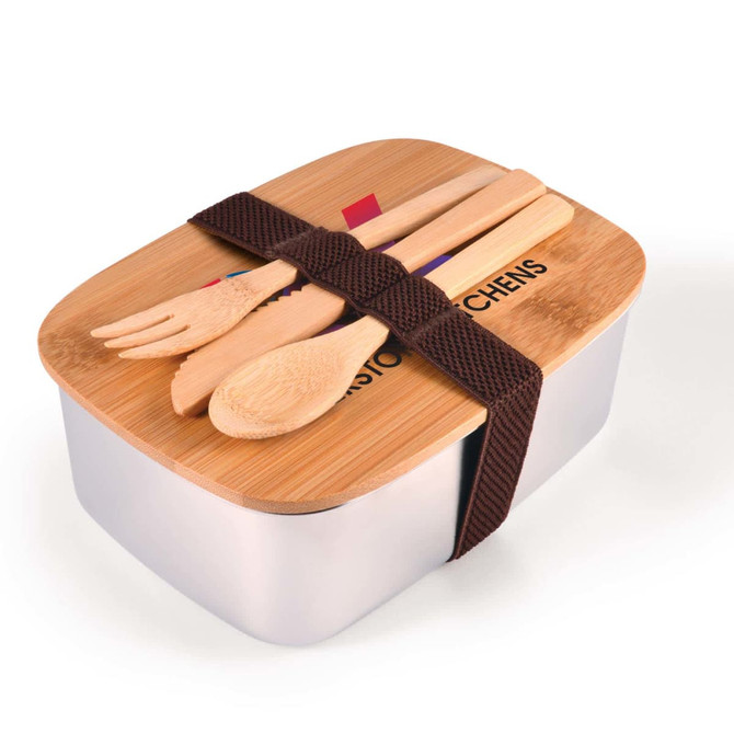 A silver lunch box with a wooden lid, featuring bamboo utensils and secured with a brown strap.