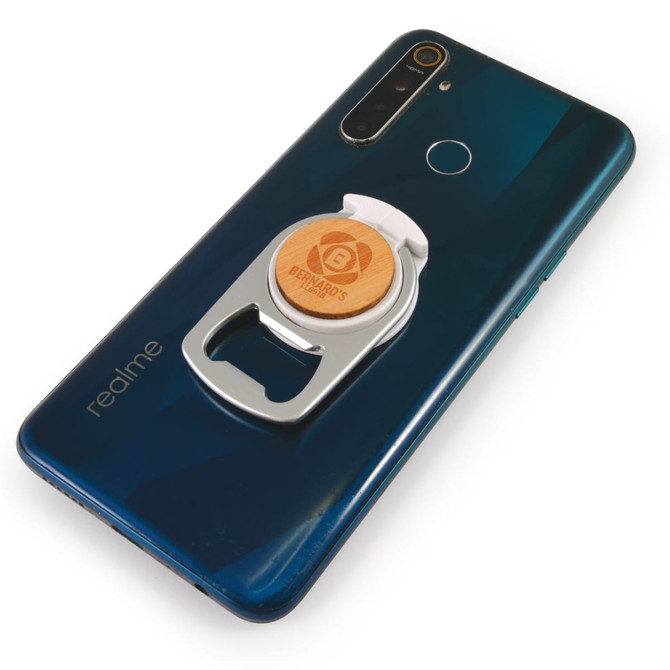 A drink bottle opener and phone stand in silver, attached to a dark blue smartphone, featuring a logo on the opener.