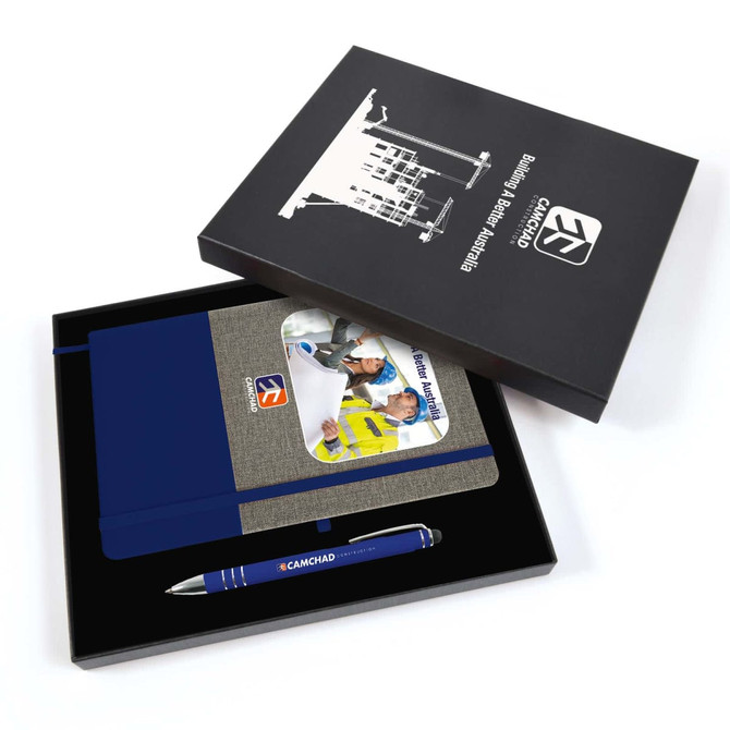 A blue pen and a gray notebook with a blue strap, presented in a black gift box with a logo.