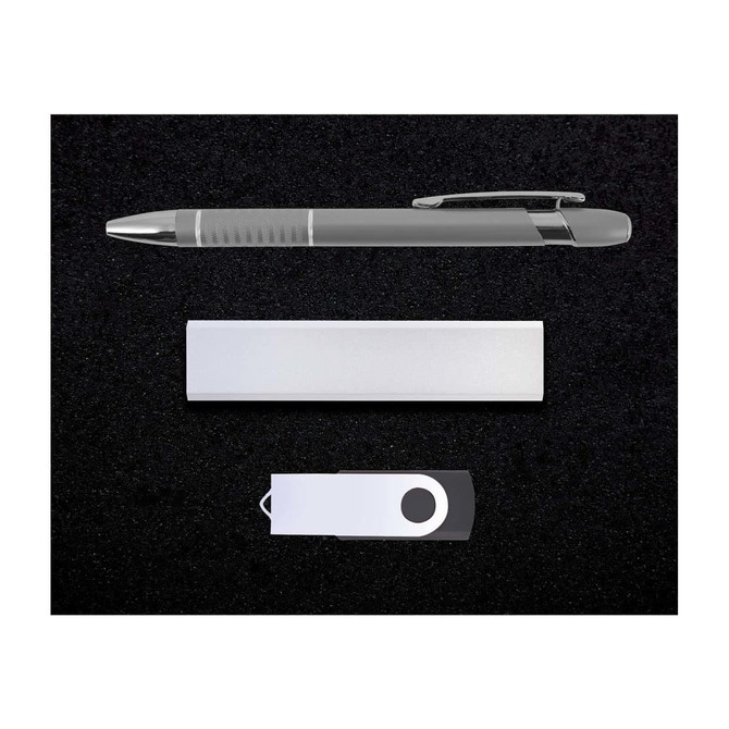 A silver pen, USB drive, and a sleek metallic note holder arranged on a black background.