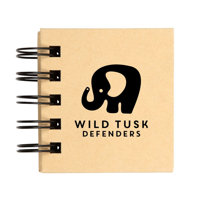 A spiral-bound notebook featuring the logo of "Wild Tusk Defenders," with a graphic of an elephant.
