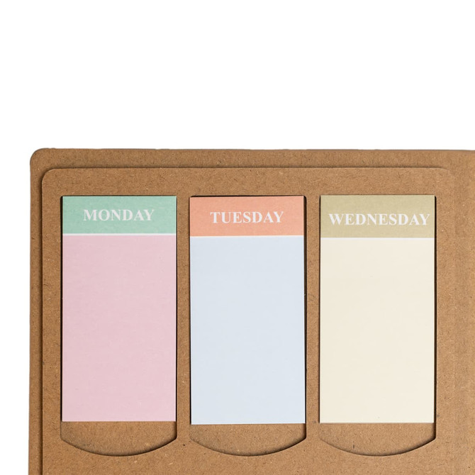 A planner with three colored tabs for Monday, Tuesday, and Wednesday, set against a brown kraft background.