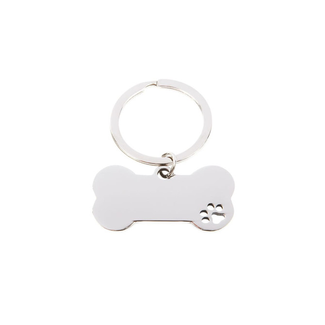 A silver keytag in the shape of a dog bone with a paw print design. It features a split ring for attachment.