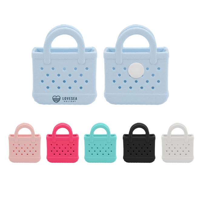 Mini EVA bag charms in pink, teal, black, and light blue, featuring perforated designs and a logo.