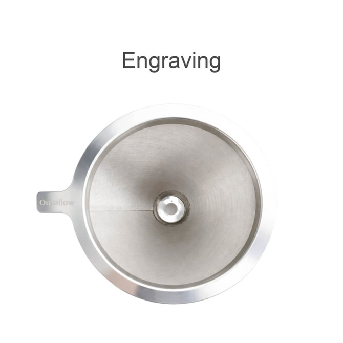 A stainless steel coffee filter with a smooth, shiny surface and a central opening, featuring a handle.