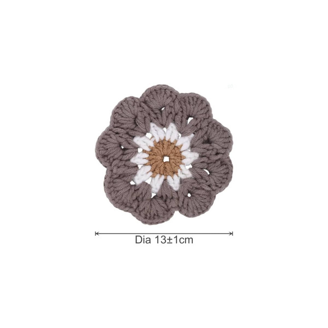 A round floral crochet motif in brown, white, and cream, measuring approximately 13 cm in diameter.