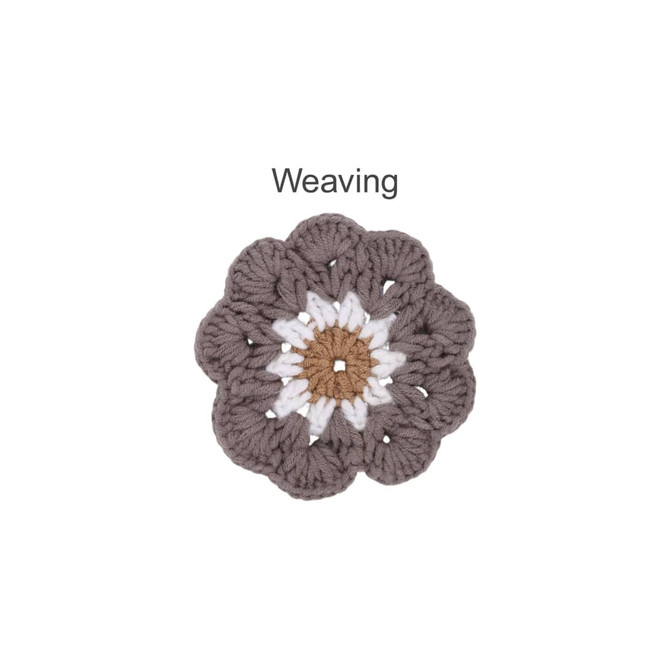 A crochet coaster designed in brown, white, and grey, resembling a flower with textured petals. It features a logo.