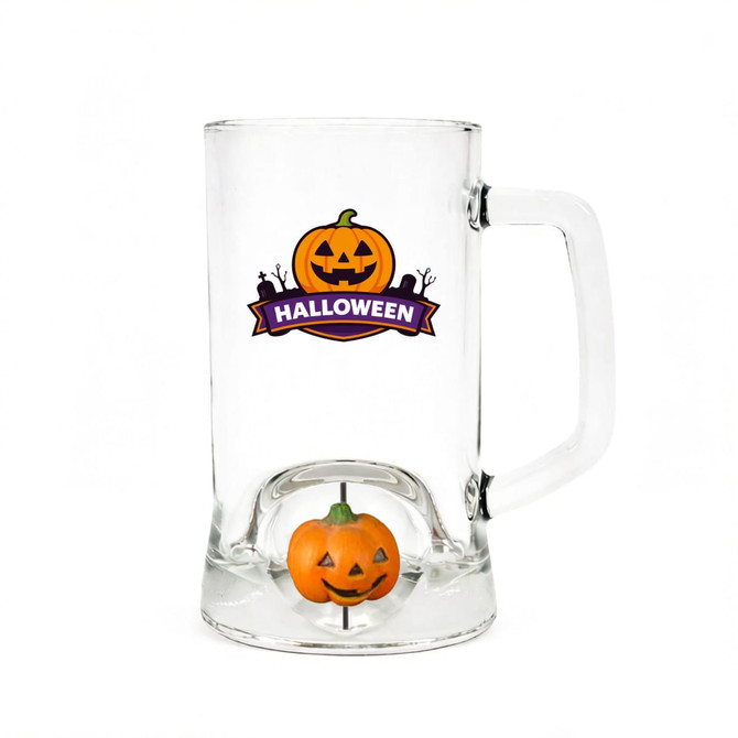 A beer glass with a pumpkin spinner toy inside. The glass is clear with a Halloween-themed design outside.
