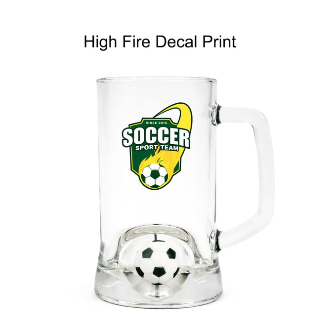 A clear glass beer mug featuring a soccer-themed design and a custom spinner toy inside.